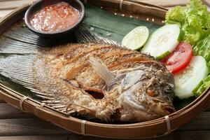 Fried gourami fish with spicy sauce photo