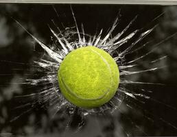 Tennis ball through broken window photo