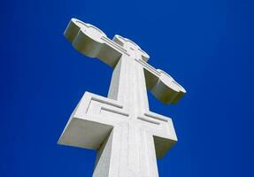 White orthodox christian cross on blue sky background. photo