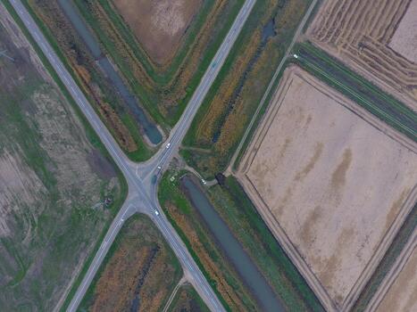 Crossroads paved roads through the fields. View from above photo
