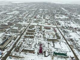 Winter view from the bird's eye view of the village. The streets are covered with snow photo