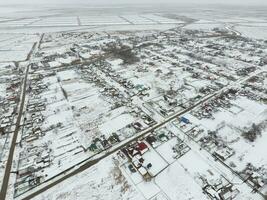 Winter view from the bird's eye view of the village. The streets are covered with snow photo