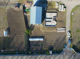 Buildings on the site. Hangar from metal profile, corrugated. The foundation of the house. photo