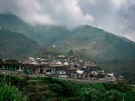 a village surrounded by mountains photo