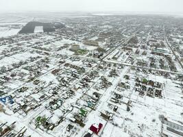 Winter view from the bird's eye view of the village. The streets are covered with snow photo