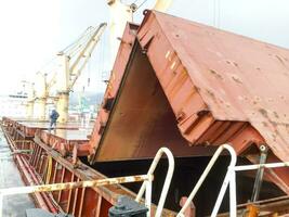 Folded steel roof of the hold on the ship. photo