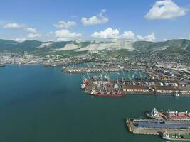 Industrial seaport, top view. Port cranes and cargo ships and ba photo