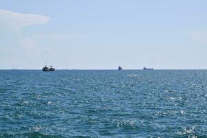 Ships on the horizon of the sea. Out at sea ships photo