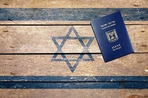 Israel passport on the table and flag photo