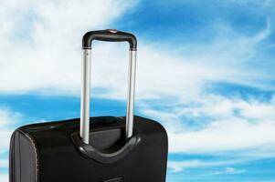 Suitcase with the sky. Travel concept photo