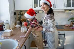 Mom and daughter they manage the white kitchen together for Christmas and new year. Family day, preparation for the holiday, learn to cook delicious pastries photo