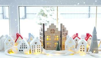 Cozy Christmas decor tiny house of small size on window sill with snow outside the window. Gift for New Year. Insurance, moving to new house, mortgage, rent and purchase real estate photo