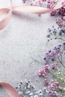 Colored gypsophila flowers on concrete background photo