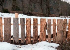 Wooden fence with the snow photo