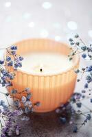 Candle and a branch of gypsophila flowers photo