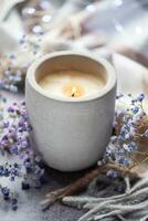 Candle and a branch of gypsophila flowers photo