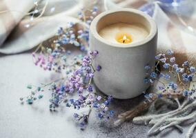 Candle and a branch of gypsophila flowers photo