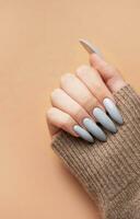 Woman's hand with grey nail polish photo