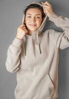 Portrait of a young pretty girl in a  hoodie photo