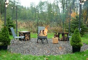 Fire pit and burning fire in a garden photo