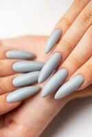 Woman's hand with grey nail polish photo