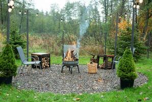 Fire pit and burning fire in a garden photo