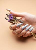 Close-up of a woman's hands with grey manicured nails photo