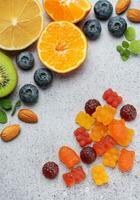 Chewable gummy vitamins and fruits photo