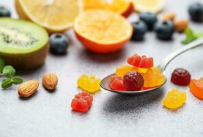 Chewable gummy vitamins and fruits photo