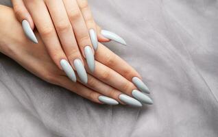 Grey nails on grey lace background. photo