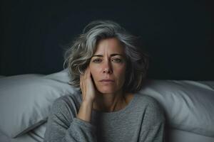 AI Generated Portrait of sad mature woman lying on bed at home in bedroom photo