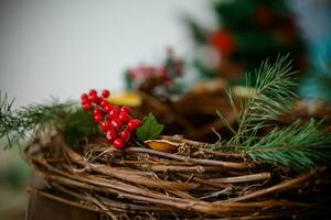 Christmas decoration with red berries on a wicker basket. Selective focus. photo