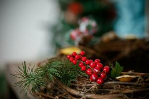 Christmas rustic wicker nest with red berries on wooden background. photo