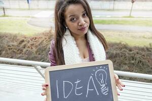 young attractive businesswoman shows a blackboard marked with business concepts photo