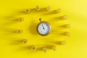 small group of fresh macaroni rigati lined up in a circle on yellow background photo