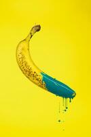 banana floating in the air with drops of green paint photo