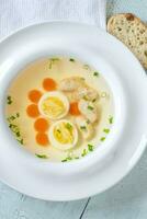 Chicken broth in plate photo