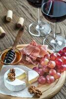 Camembert cheese with glasses of red wine photo