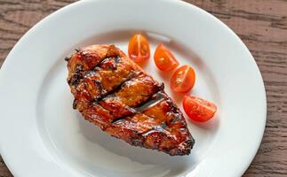 Grilled chicken steak with cherry tomatoes photo