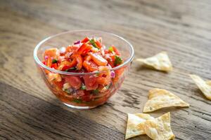 Bowl of salsa with tortilla chips photo