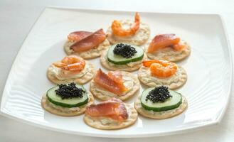 Canape with seafood on the plate photo