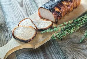 Pork loin wrapped in bacon photo