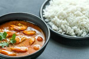 Thai yellow curry with seafood and white rice photo