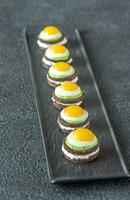 Canape with fried quail eggs photo