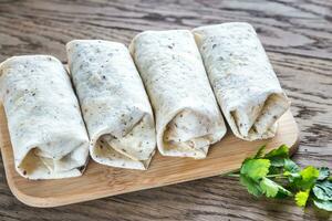 Chicken burritos on the wooden background photo