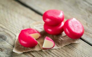 Stack of mini cheese on the wooden table photo