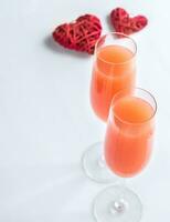 Two bellini cocktails with hearts photo