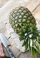 Pineapple on the wooden background photo