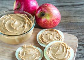 Slices of apples with peanut butter photo