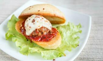 Sandwich with meatball in tomato sauce and mozzarella photo